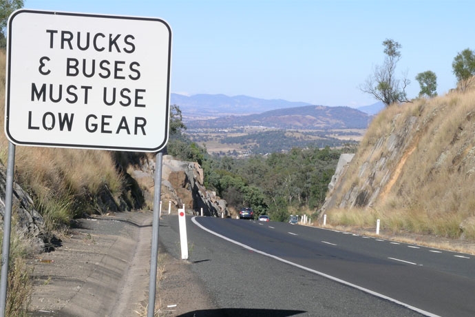 ‘Trucks and Buses Must Use Low Gear’ Stay in control on a steep descent